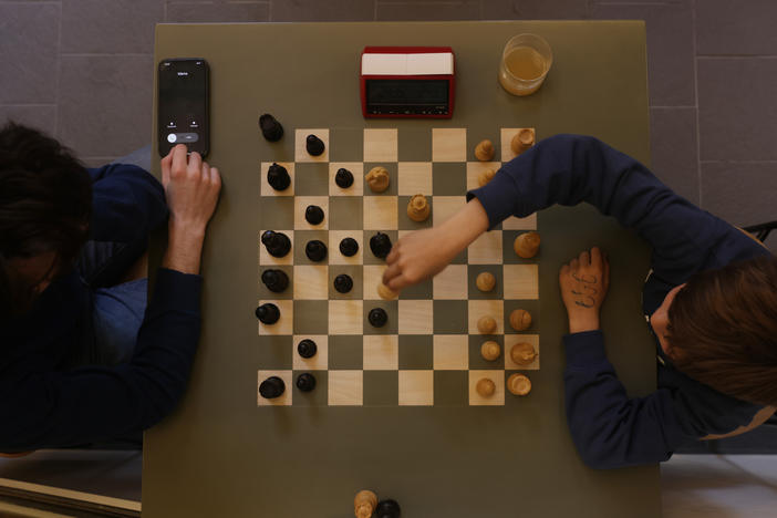 Visitors play chess at The World Chess Club Berlin in Germany on May 9. The German Chess Federation described the new international policies for transgender chess players as discriminatory.