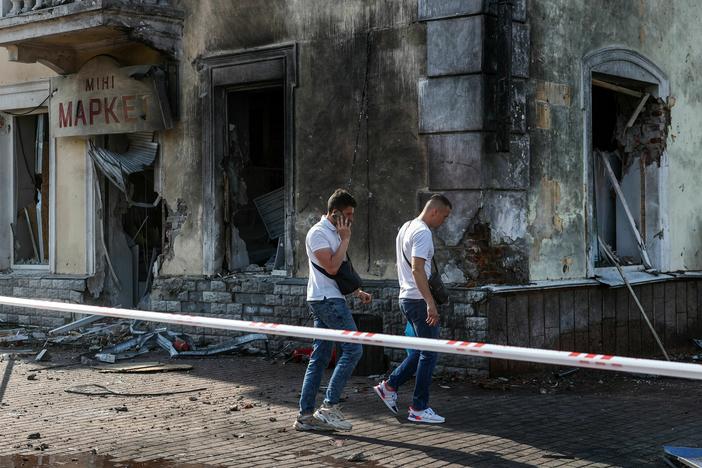 Law enforcement officers inspect the site of a missile strike in Chernihiv, Ukraine, on Saturday.