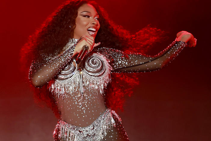 Megan Thee Stallion performs onstage during the 2023 LA Pride in the Park Festival. In the first episode of its second season, the <em>Louder Than A Riot</em> podcast examines the backlash Megan faced after being shot by rapper Tory Lanez.