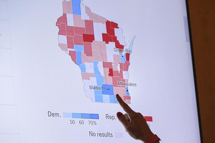 A supporter of Wisconsin Republican gubernatorial candidate Tim Michels points to incoming election data on Nov. 8, 2022, in Milwaukee. When Republican candidates for president gather for their first debate Wednesday in Milwaukee, the spotlight will not only be on them, but Wisconsin's role as one of a shrinking handful of genuine battleground states.
