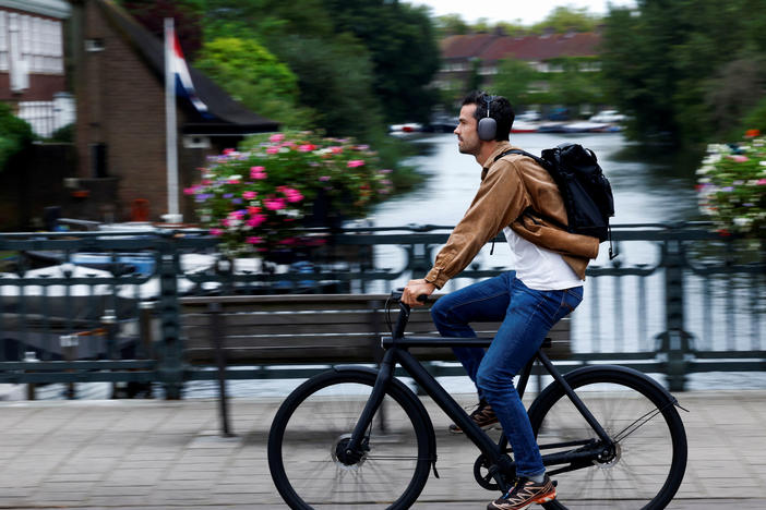 A man rides a VanMoof brand e-bike in Amsterdam, Netherlands, Aug. 17.