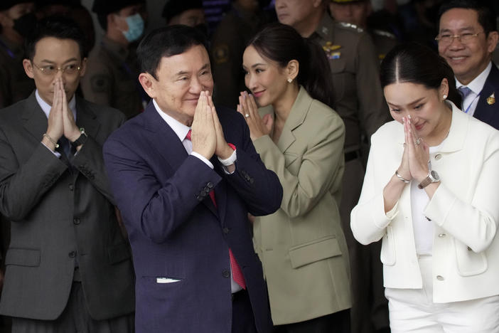 Thailand's former Prime Minister Thaksin Shinawatra, foreground, with, from left, his son Phantongtae, his daughters Pinthongta and Paetongtarn, arrive at Don Muang airport in Bangkok, Thailand, Tuesday, Aug. 22, 2023.