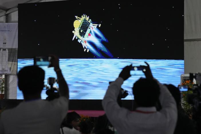 Journalists film the live telecast of spacecraft Chandrayaan-3 landing on the moon at ISRO's Telemetry, Tracking and Command Network facility in Bengaluru, India, on Wednesday, Aug. 23, 2023.
