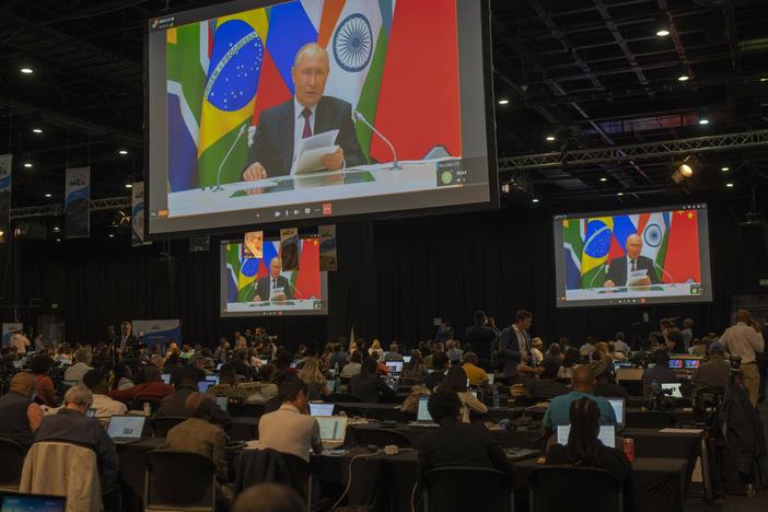 Members of the media watch Russia's President Vladimir Putin address via videolink the 2023 BRICS Summit in Johannesburg, South Africa, Wednesday, Aug. 23, 2023.