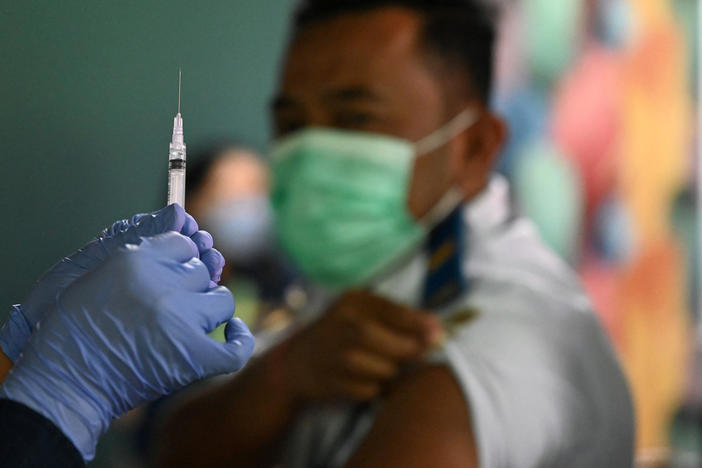 A booster vaccine is administered on the Indonesian resort island of Bali.