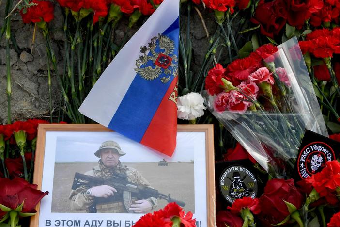 A portrait of Yevgeny Prigozhin is seen among flowers at a makeshift memorial in front of the Wagner Group headquarters in St. Petersburg, Friday. Prigozhin and other members of the mercenary company are believed to have died in a plane crash in Russia.