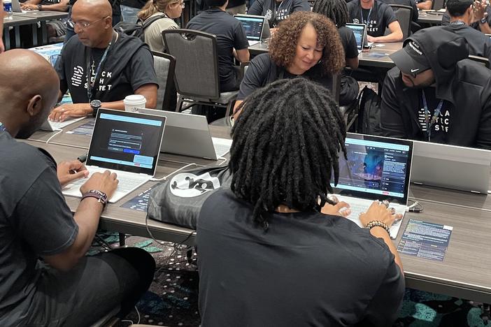 Marvin Jones (left) and Rose Washington-Jones (center), from Tulsa, Okla., took part in the AI red-teaming challenge at Def Con earlier this month with Black Tech Street.