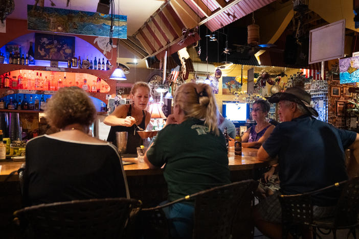 Cori Gross, bartender at Java Jazz, greets residents with bursts of joy to see that they've survived the fires.