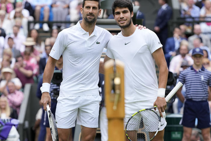 Serbia's Novak Djokovic, left, and Spain's Carlos Alcaraz pose for a photo ahead of the final of the men's singles on day fourteen of the Wimbledon tennis championships in London, Sunday, July 16, 2023.