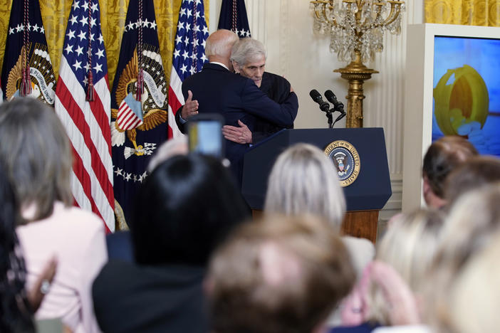President Biden hugs Steven Hadfield, a Medicare recipient who takes expensive drugs, at an event on prescription drug costs at the White House on Aug. 29.
