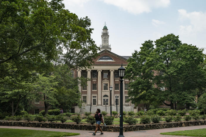 People walk on the campus of the University of North Carolina Chapel Hill in June.