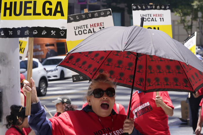 Striking hotel workers rally outside the InterContinental Los Angeles Downtown Hotel on Tuesday, July 4, 2023. (AP Photo/Damian Dovarganes)