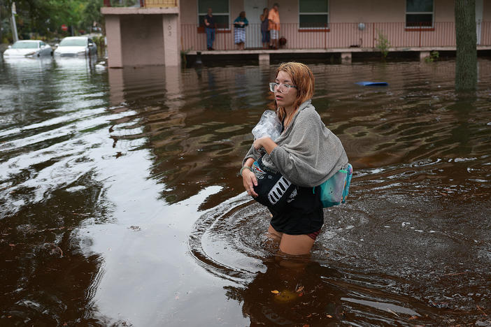Makatla Ritchter wades through flood waters after having to evacuate her home when the flood waters from Hurricane Idalia inundated it on August 30, 2023 in Tarpon Springs, Florida.