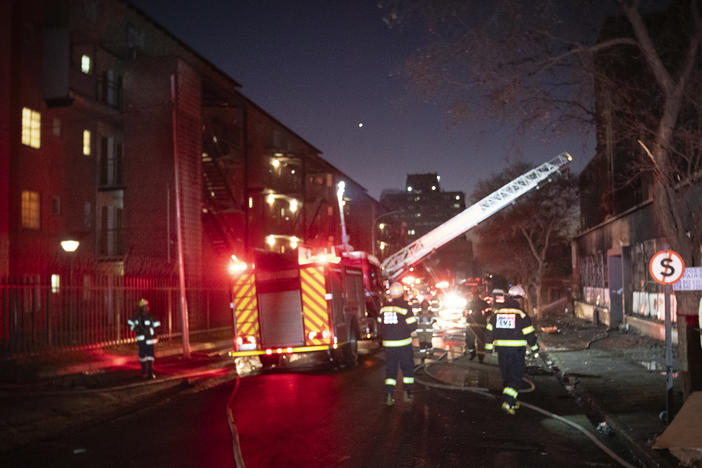 Firefighters work on the scene of a deadly blaze in downtown Johannesburg Thursday, Aug. 31, 2023.