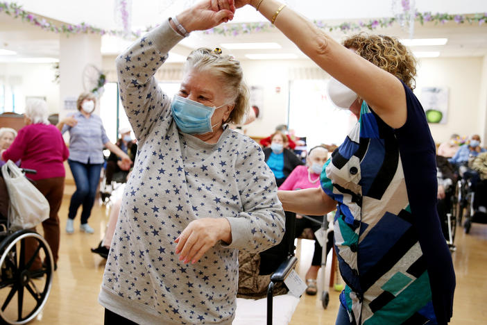 Residents and staff gather for a dance at the Ararat Nursing Facility in Los Angeles in April 2021. The pandemic exposed the dangers of inadequate staffing at nursing homes.