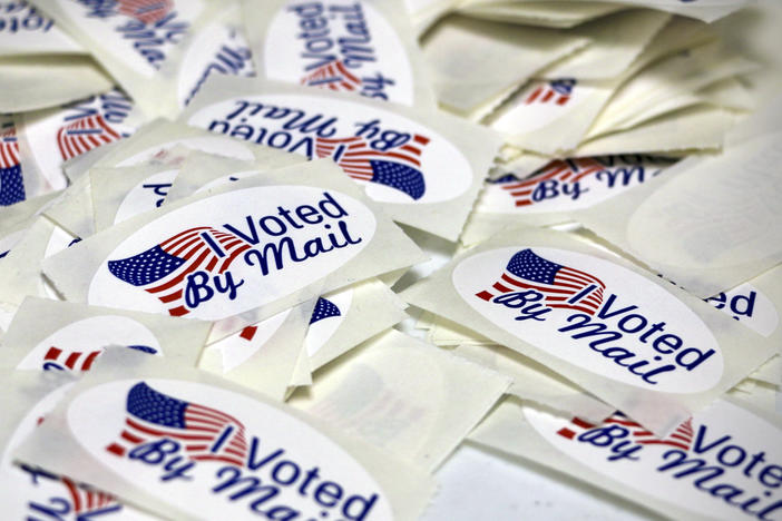Stickers reading "I Voted By Mail" are displayed as the Wayne County Board of Elections prepares absentee ballots in Goldsboro, N.C., on Sept. 22, 2022. A Republican-backed bill would eliminate a grace period for mail ballots to arrive.