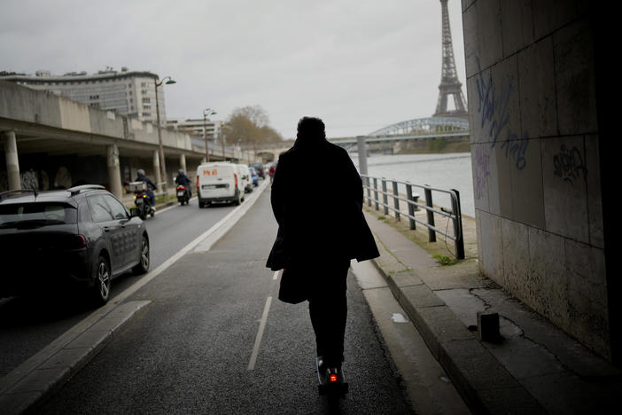 A man rides a scooter in Paris, on March 31. The city has now banned rental electric scooters.