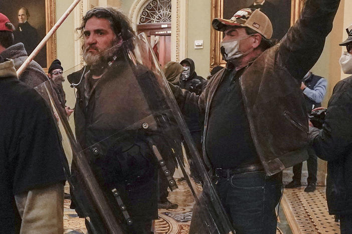 Rioters, including Dominic Pezzola, center with police shield, are confronted by U.S. Capitol Police officers outside the Senate Chamber inside the Capitol on Jan. 6, 2021, in Washington, D.C.