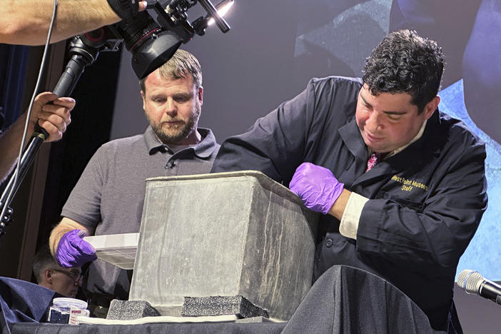 A West Point archeologist and  museum curator take part in the opening of a lead box placed in the base of a monument by cadets almost two centuries ago.