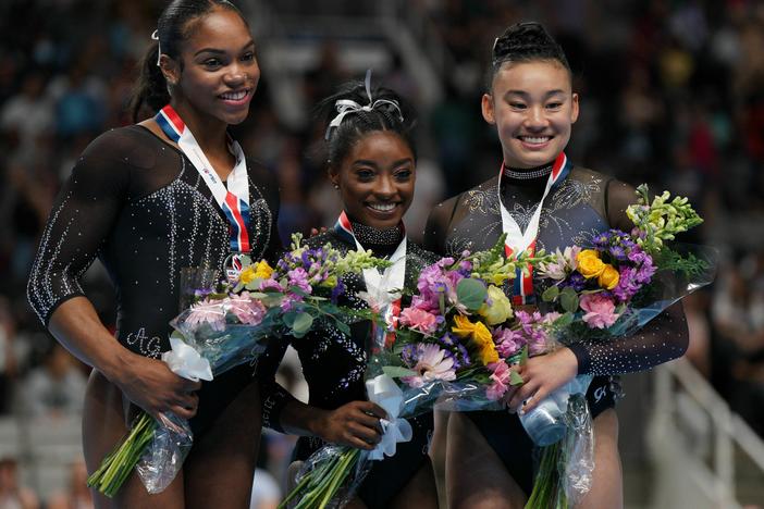 Gymnasts Shilese Jones, Simone Biles and Leanne Wong pose after placing second, first and third in the all-around competition on the final day of women's competition at the 2023 U.S. Gymnastics Championships on Sunday in San Jose, Calif.