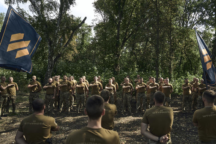 Soldiers of Ukraine's 3rd Separate Assault Brigade shout slogans as they stand in line near Bakhmut, the site of fierce battles with the Russian forces in the Donetsk region, Ukraine, on Sunday.