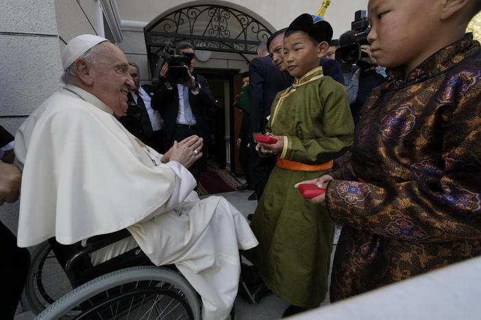 Children in traditional dress welcome Pope Francis arriving for a meeting with charity workers and for the inauguration of the House of Mercy in Ulaanbaatar, Monday, Sept. 4, 2023.