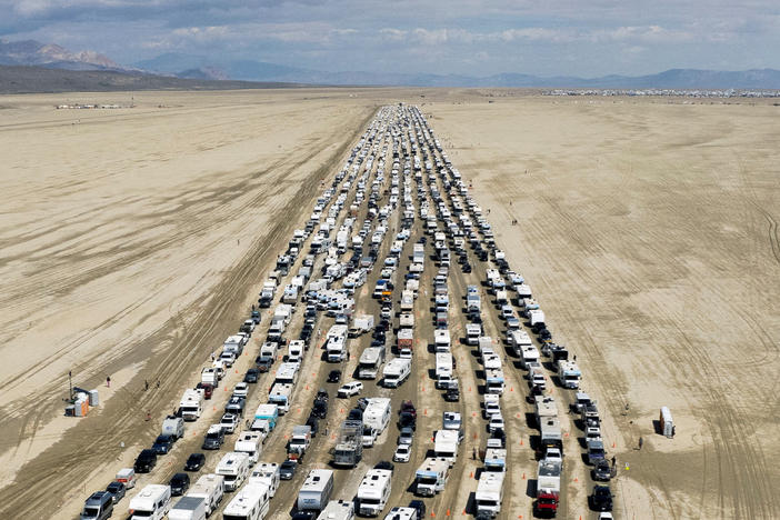 Vehicles seen departing the Burning Man festival in Black Rock City, Nev., on Monday.