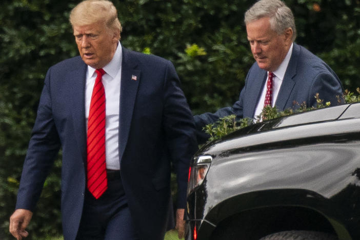 Then-President Donald Trump talks to White House chief of staff Mark Meadows, right, as they walk from the Oval Office at the White House on Sept. 12, 2020.