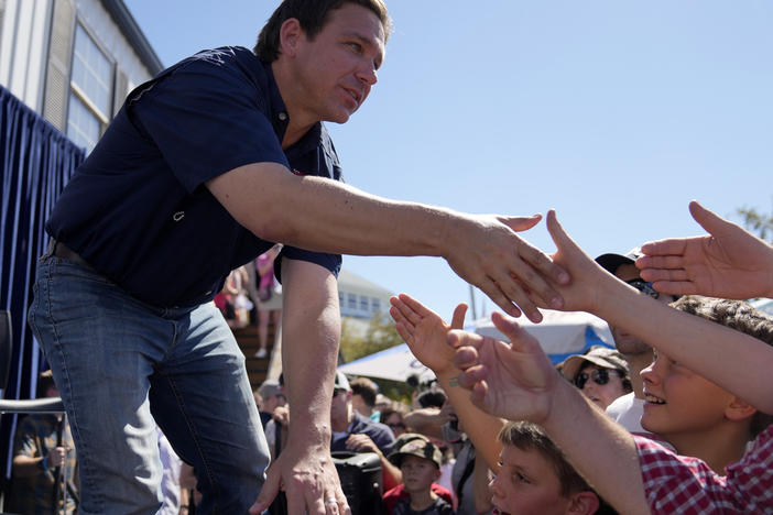 Republican presidential candidate and Florida Gov. Ron DeSantis shakes hands with fairgoers at the Iowa State Fair on Aug. 12 in Des Moines, Iowa.