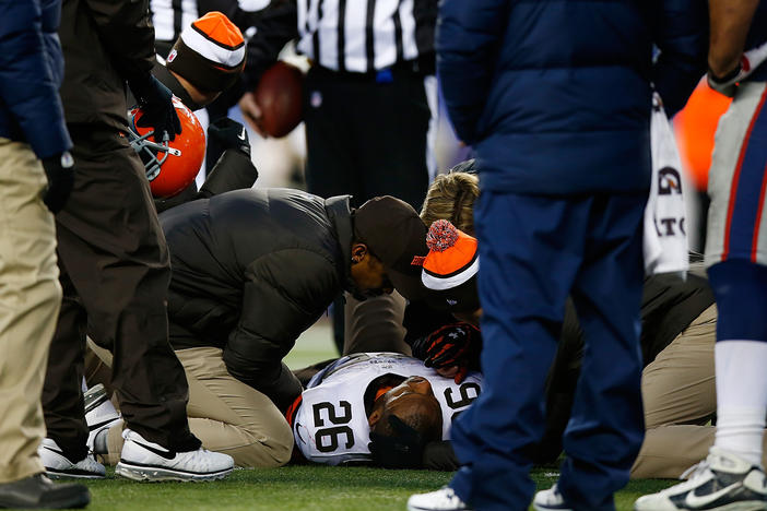 Willis McGahee, No. 26 of the Cleveland Browns, is tended to on the field in the fourth quarter of a game against the New England Patriots at Gillette Stadium in Foxboro, Mass., on Dec. 8, 2013,