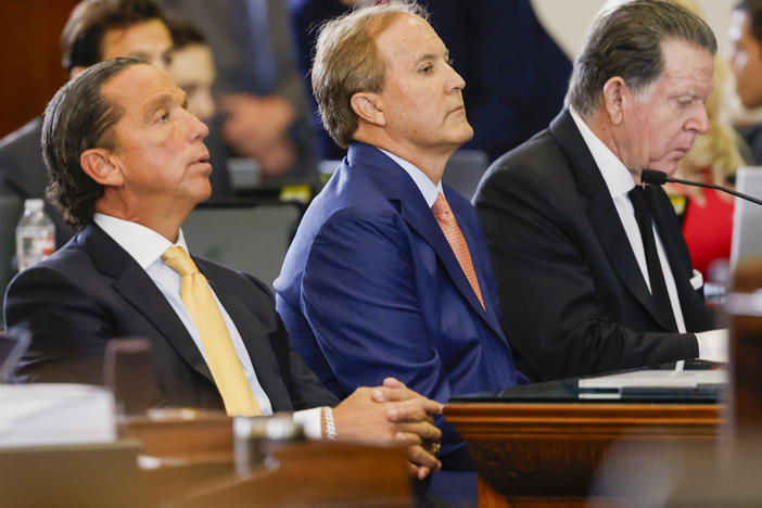 Suspended Texas AG Ken Paxton (center) sits with his legal team at the start of his impeachment trial in the Texas Statehouse. Paxton pleaded not guilty on all counts.