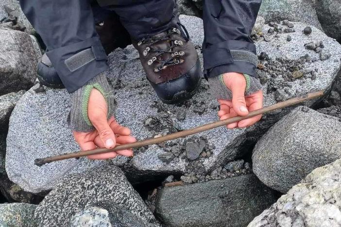 An archaeologist holds an arrow originally believed to be from the Iron Age on Mount Lauvhøe in Norway. Upon closer inspection, the team determined the artifact is from the Stone Age and is likely around 4,000 years old.
