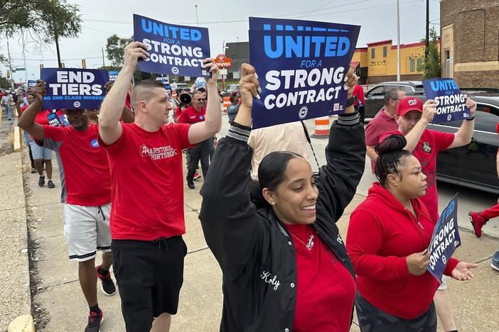 United Auto Workers members march while holding signs at a union rally held near a Stellantis factory Wednesday, Aug. 23, 2023, in Detroit.