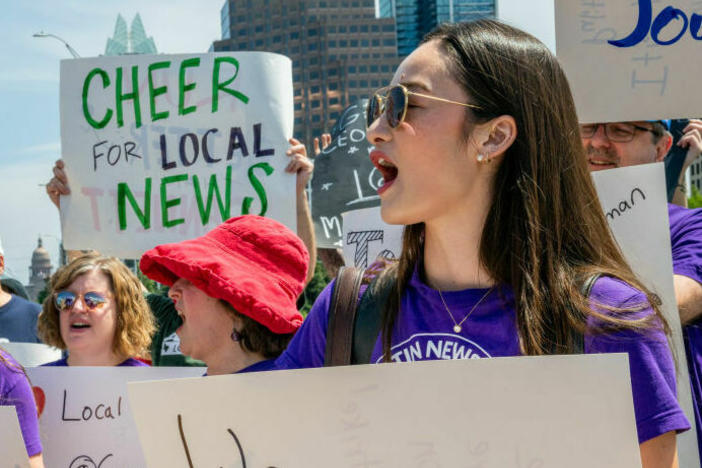 Journalists protest outside the offices of the <em>Austin American Statesman</em> in June as part of a nationwide effort by staff at Gannett-owned newspapers to draw attention to layoffs and budget cuts. A coalition of donors is promising to bolster local news with a half-billion dollars over five years.