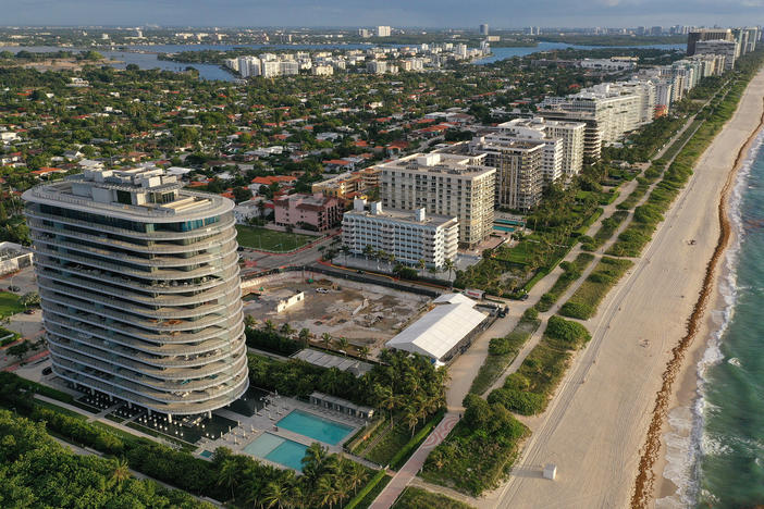 In an aerial view, a cleared lot where the 12-story Champlain Towers South condo building once stood is seen on June 22, 2022 in Surfside, Fla. Ninety-eight people died when the building partially collapsed on June 24, 2021.