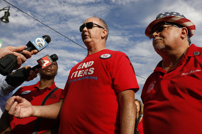 United Auto Workers President Shawn Fain talks with the news media before marching in the Detroit Labor Day Parade on September 4, 2023 in Detroit, Michigan.