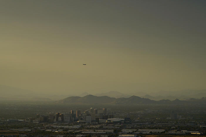 Clouds surround downtown Phoenix at sunset on July 30, 2023.