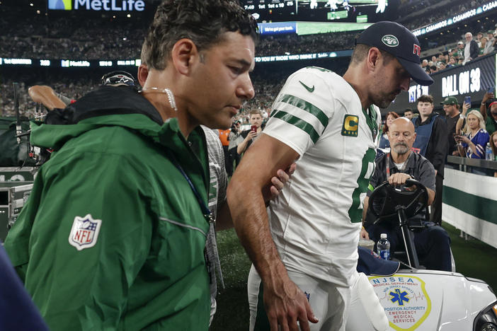 New York Jets quarterback Aaron Rodgers is helped off the field during the first quarter of an NFL football game against the Buffalo Bills on Monday in East Rutherford, N.J.
