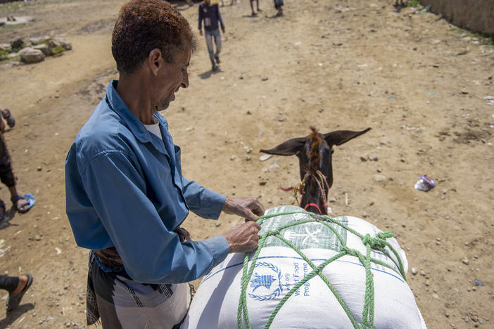 Displaced Yemenis receive humanitarian aid provided by the World Food Programme in the city of Taiz on September 11.