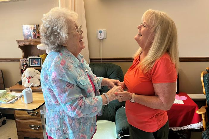 Sharon Hudson (left) has advanced Alzheimer's. But she smiles and giggles when her daughter, Lana Obermeyer, visits at the Good Samaritan Society nursing home in Syracuse, Nebraska.