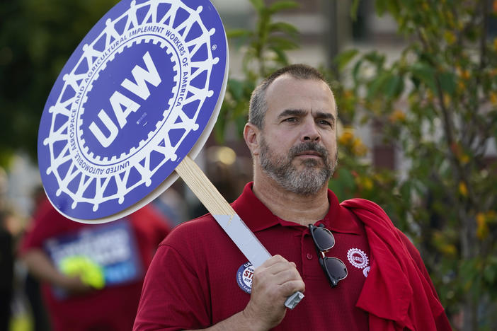 A United Auto Workers member walks in the Labor Day parade in Detroit on Sept. 4, 2023. The UAW is on the verge of a historic strike unless it can clinch a deal with the Big Three automakers by a deadline on midnight.