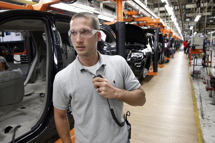 In this Wednesday, May 8, 2013 photo, Jeff Caldwell, 29, a chassis assembly line supervisor, monitors the assembly line at the Chrysler Jefferson North Assembly plant in Detroit.