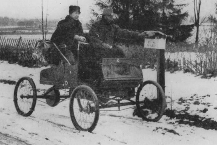 A rural mail carrier in 1905 trying out new transportation technology.