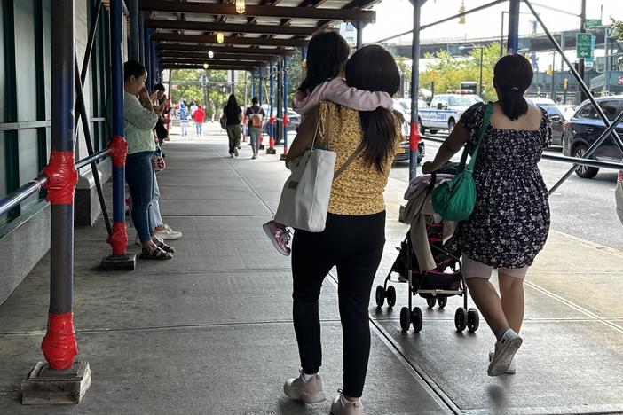 Families walk in and out of the Department of Education in Long Island City.