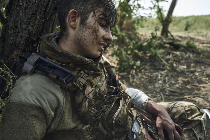 A wounded Ukrainian soldier who goes by the call sign Flame awaits evacuation after being injured in fighting near the eastern town of Bakhmut, Ukraine, on Sept. 4. Ukraine has been waging an offensive against Russian forces since June, but so far has made only limited gains.