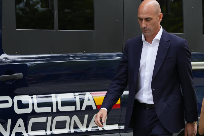 The former president of Spain's soccer federation, Luis Rubiales, passes a police van as he leaves a court appearance in Madrid on Friday.