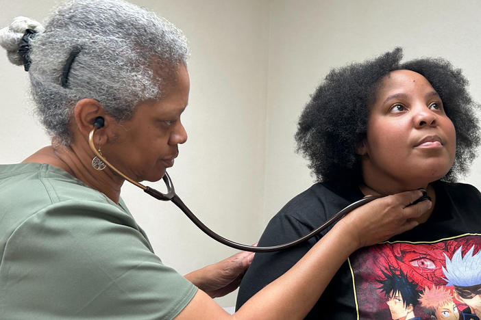 Dr. Terry Vester examines Charity Hodge at Vester's clinic in LaFayette, Alabama. Vester and her husband are the only primary care doctors in the community.