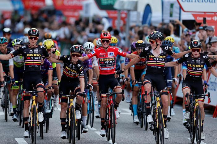 U.S. rider Sepp Kuss (center) celebrates with teammates winning while crossing the finish line of the 21st and last stage of the 2023 La Vuelta cycling tour of Spain, on Sunday.