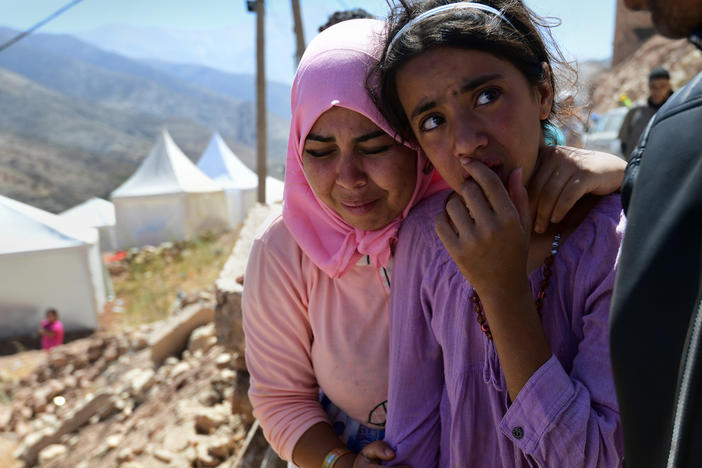 Souad Ait Hmad el Haych (left), 25, grieves as the body of her cousin is buried in Imi N'Tala, Morocco, on Sept. 13.