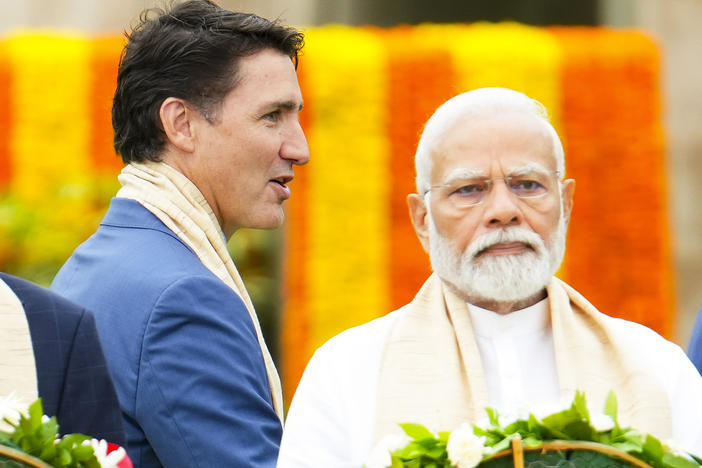 Canada's Prime Minister Justin Trudeau, left, walks past India's Prime Minister Narendra Modi as they take part in a wreath-laying ceremony at Raj Ghat (Mahatma Gandhi's cremation site) during the G20 Summit in New Delhi, Sunday, Sept. 10, 2023.